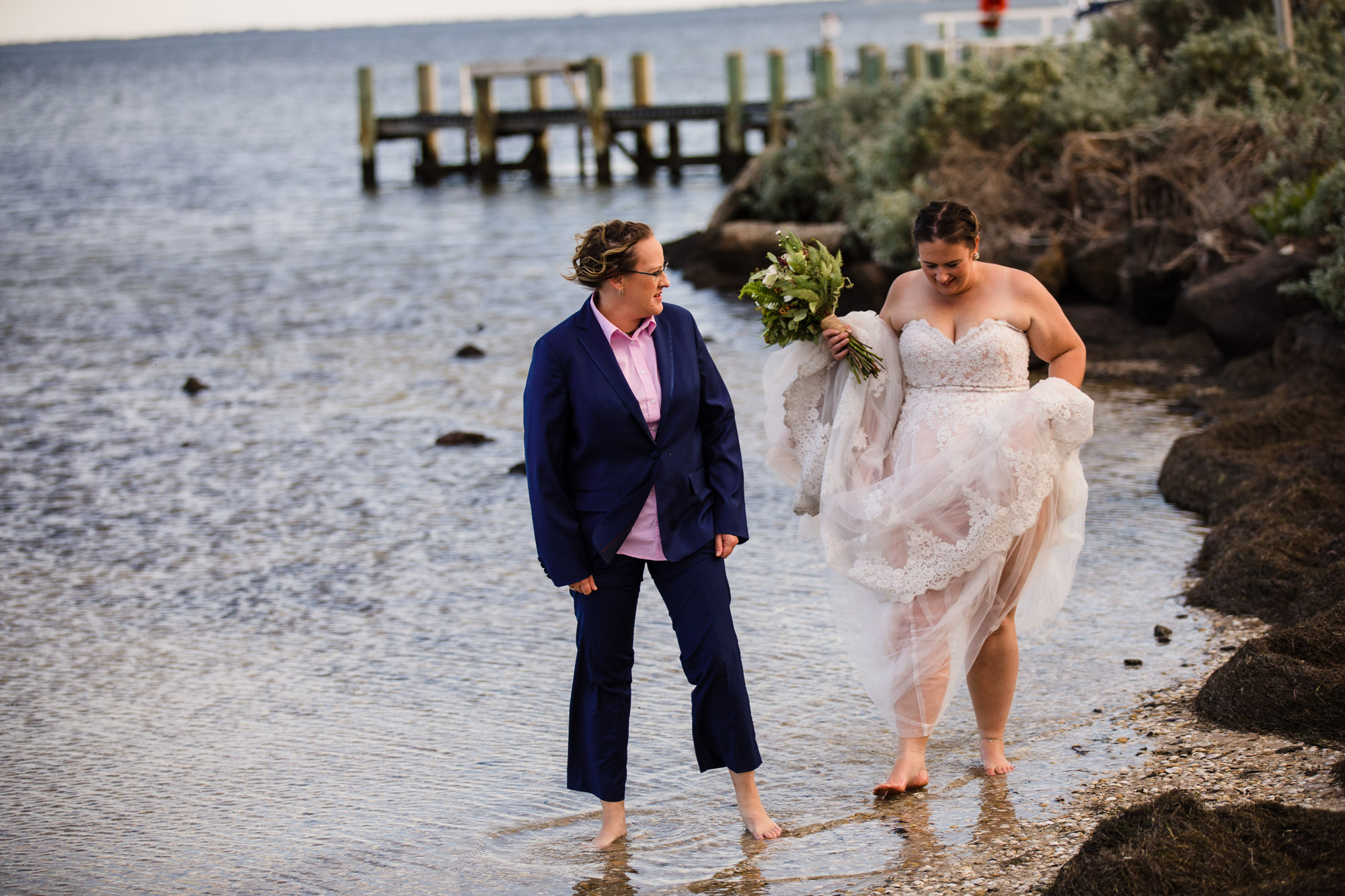 brides walking in the water at  Avalon Beach during a covid 19 wedding elopement