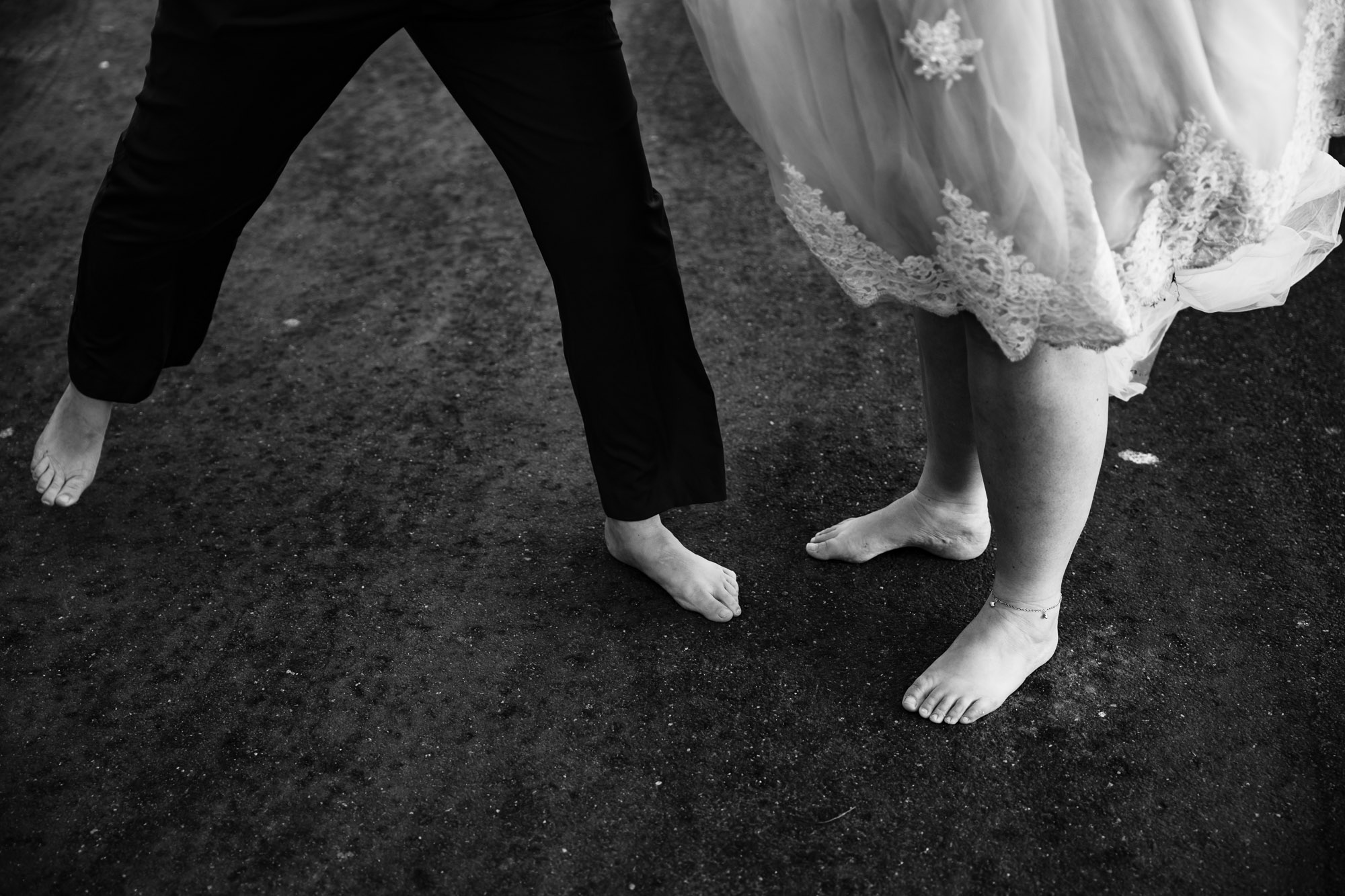 back and white image of two brides barefoot