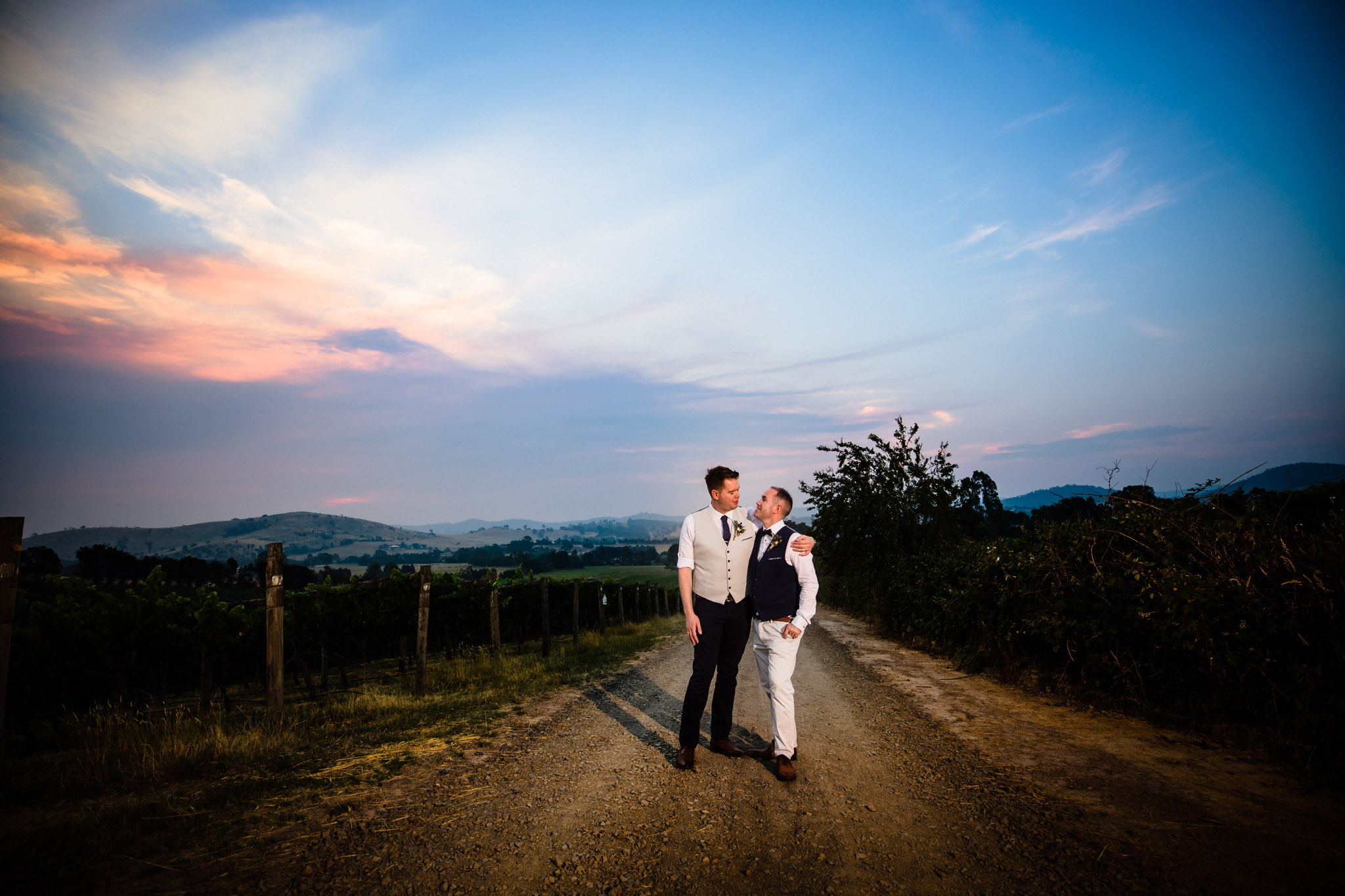 sunset portrait of two grooms at immerse winery wedding